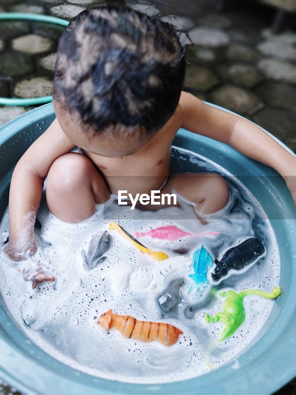 High angle view of boy playing with water