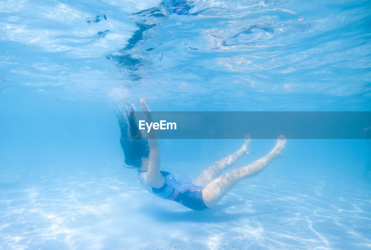 Full length of woman swimming in pool