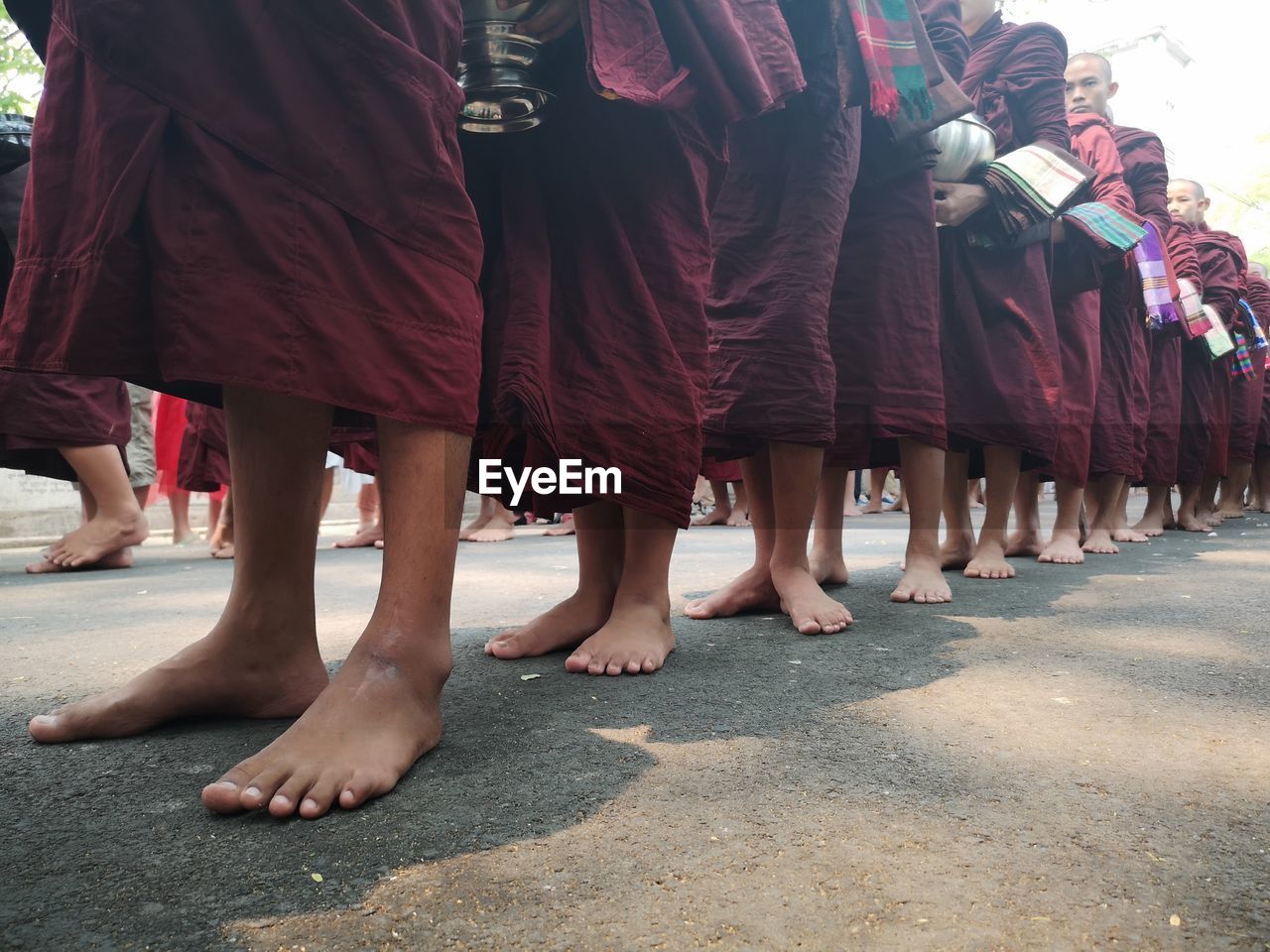 LOW SECTION OF PEOPLE STANDING ON STREET AGAINST CITY