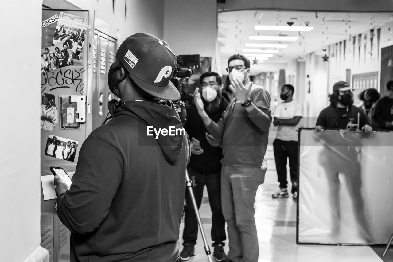 GROUP OF PEOPLE STANDING ON STORE