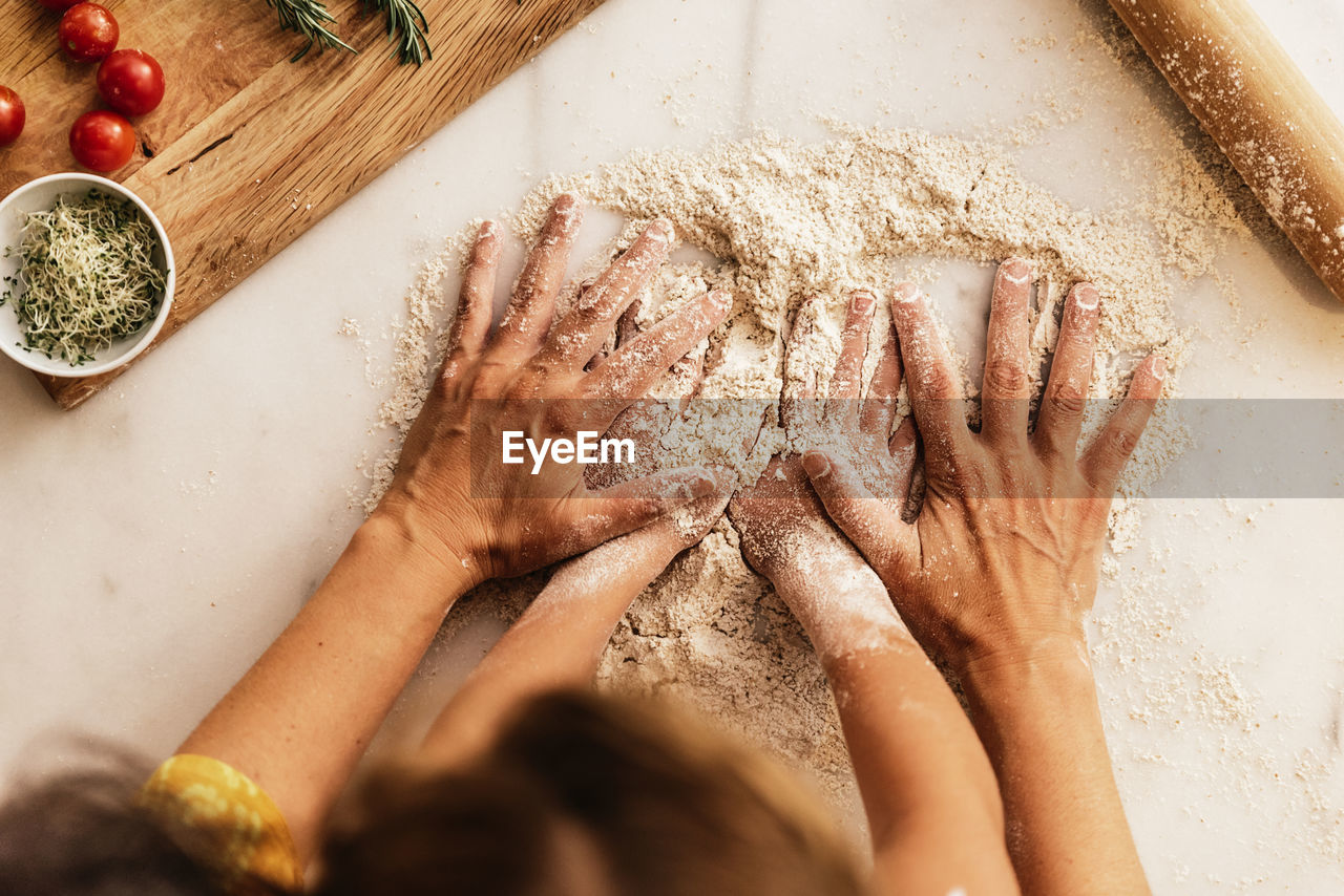 High angle view of mother and child preparing food