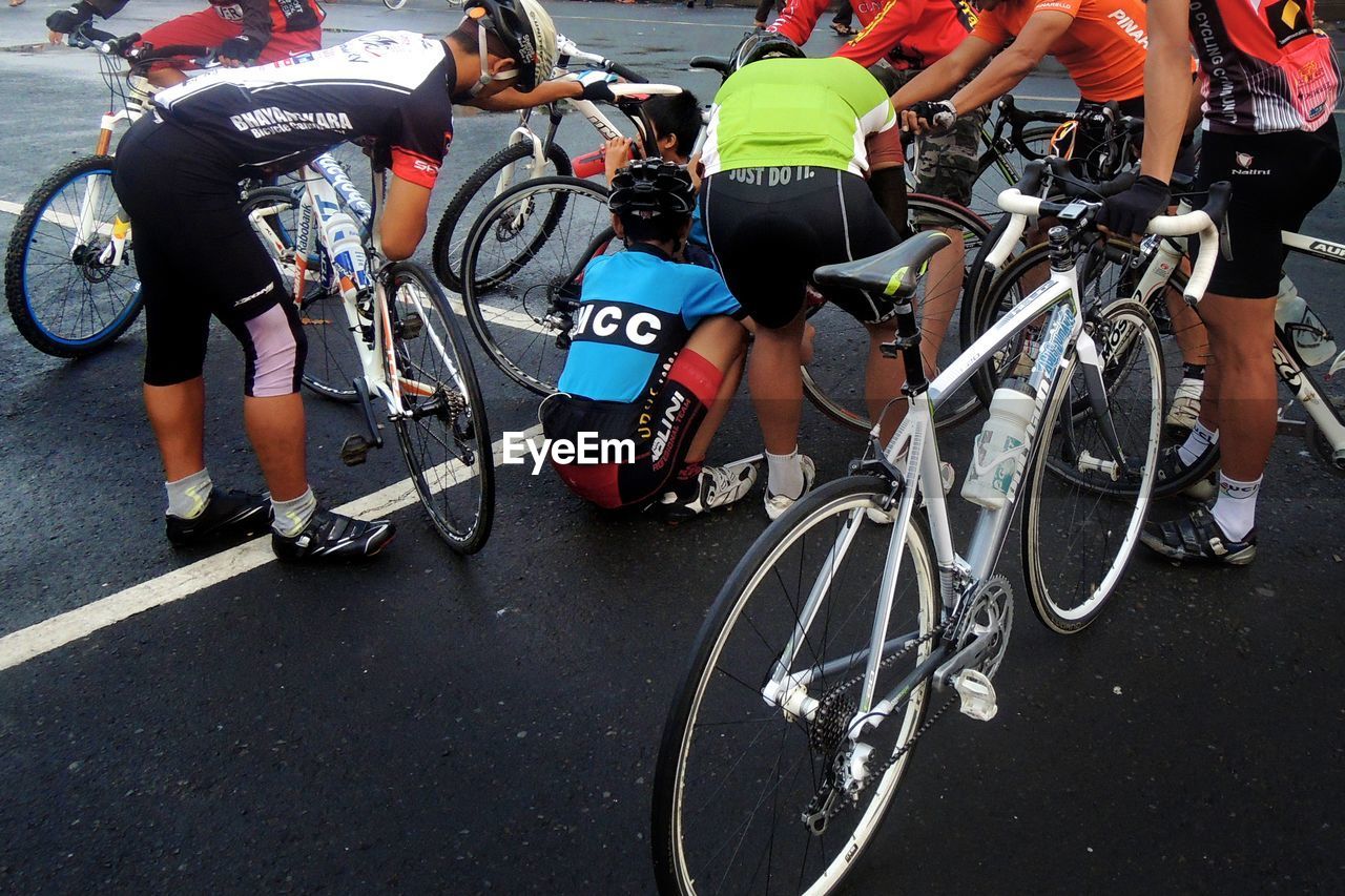 PEOPLE RIDING BICYCLES ON STREET