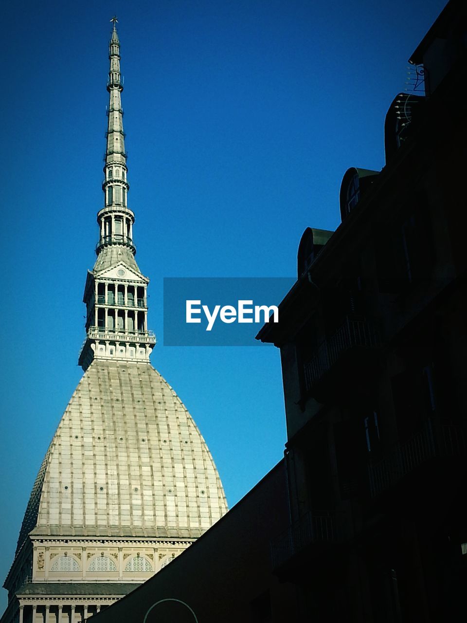 Low angle view of buildings against blue sky