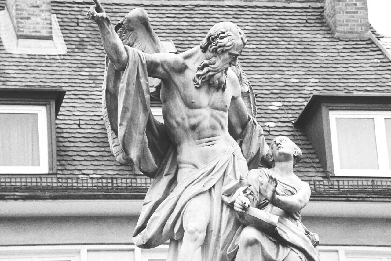 Low angle view of statue against building