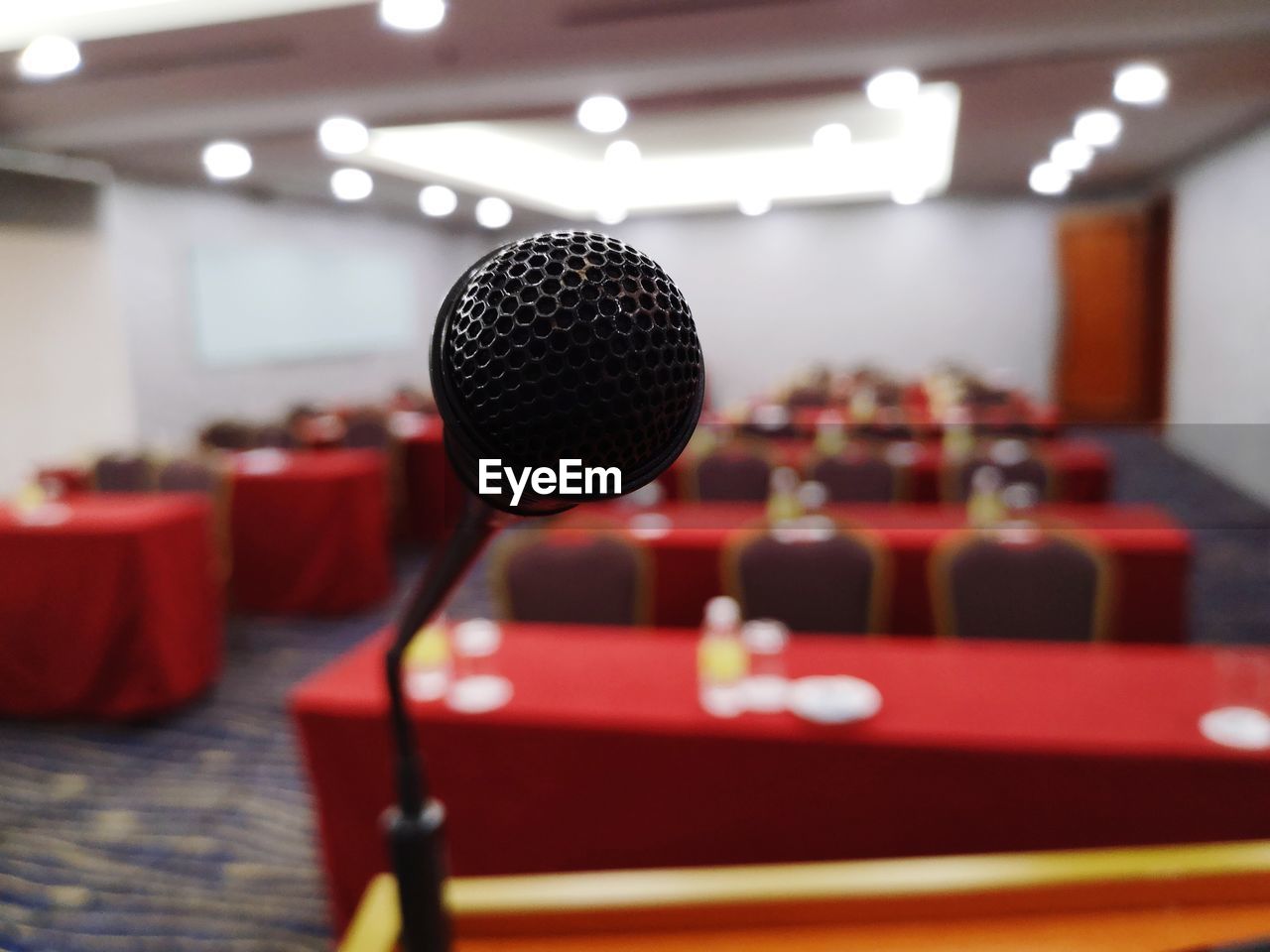 Close-up of microphone against furniture in room