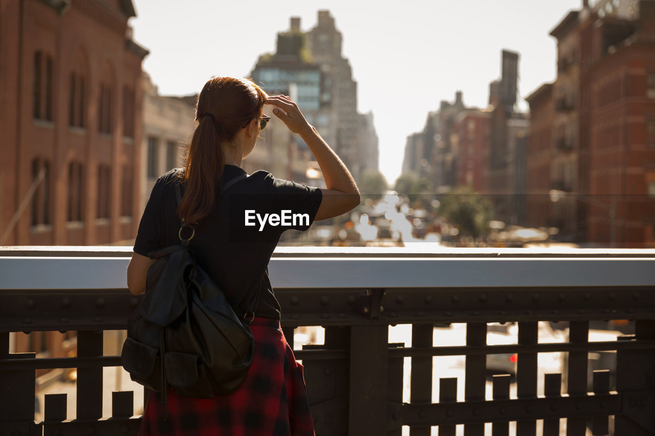 Rear view of woman looking at cityscape 