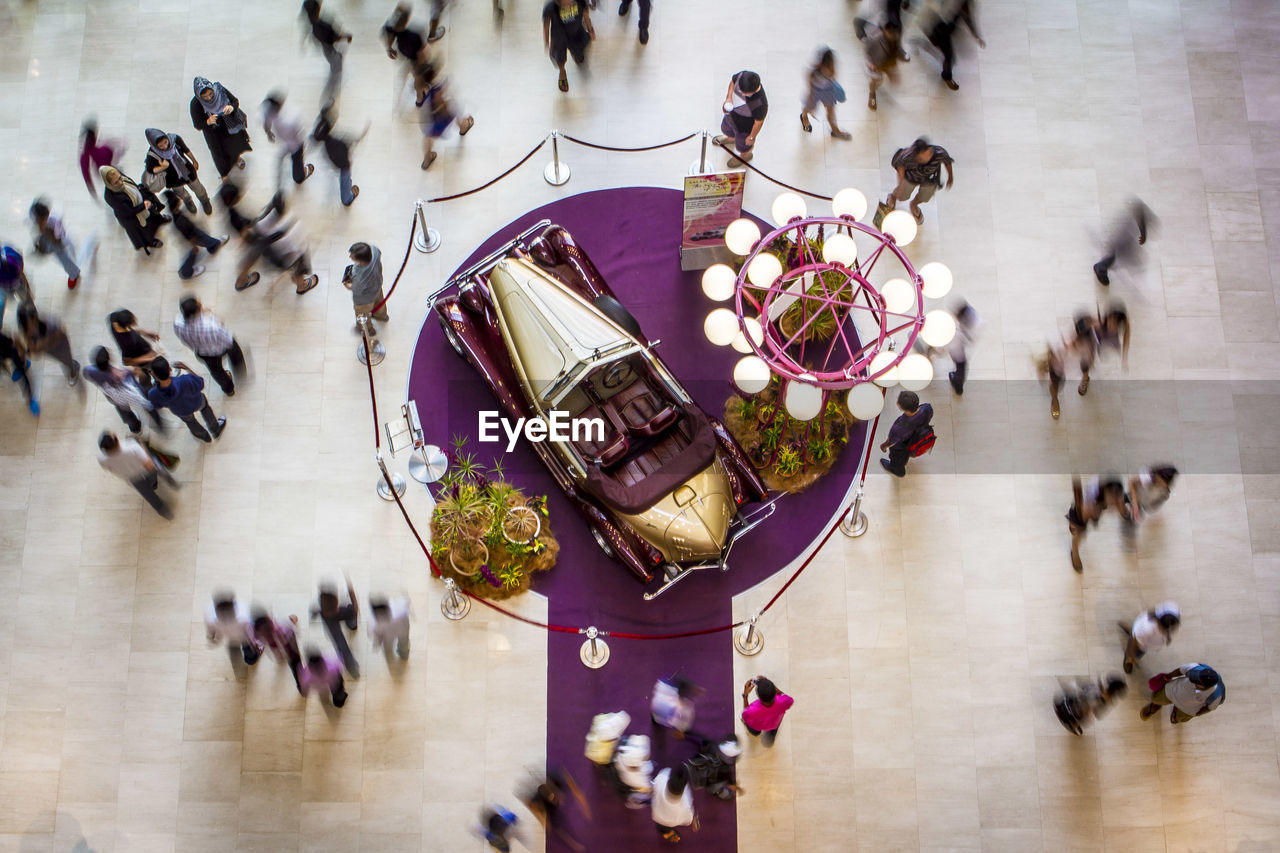 HIGH ANGLE VIEW OF PEOPLE WALKING ON FOOTPATH