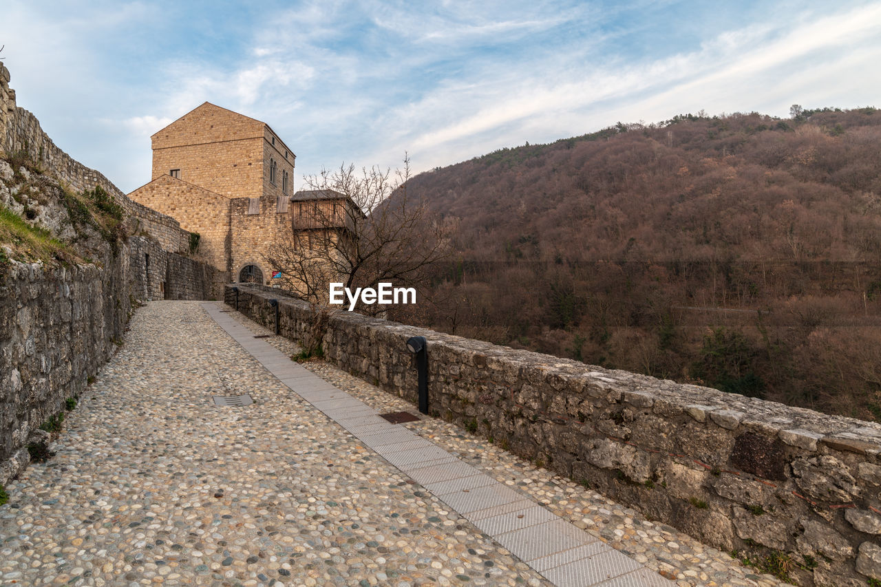 Sunset on the ancient castle of ragogna, italy. fortress guarding the ford on the river tagliamento