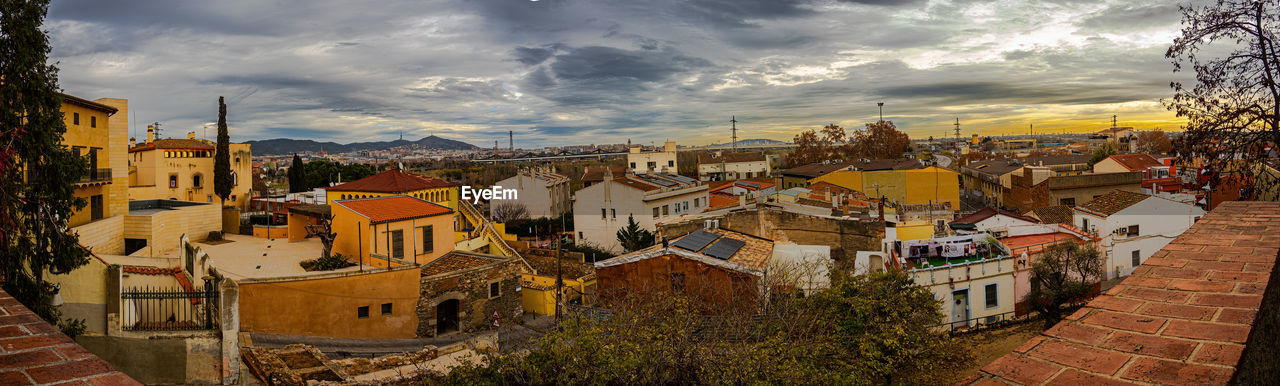 architecture, town, building exterior, city, cityscape, built structure, building, sky, cloud, evening, nature, residential district, urban area, travel destinations, house, high angle view, street, sunset, roof, travel, tree, no people, neighbourhood, plant, outdoors, panoramic, multi colored, landscape, history, tourism, the past, dusk, city street, religion, autumn, old, city life