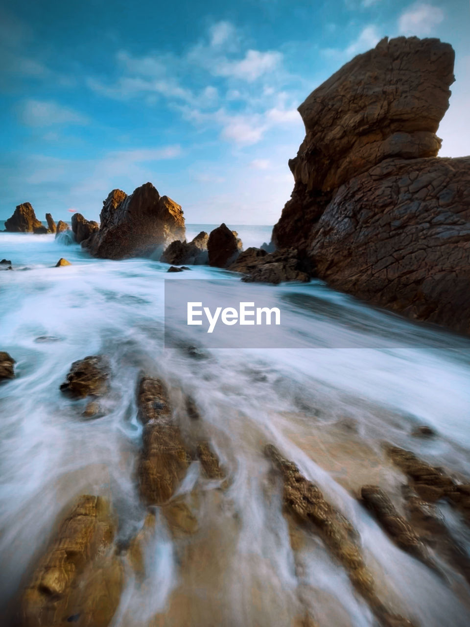 ROCK FORMATIONS ON SEA AGAINST SKY