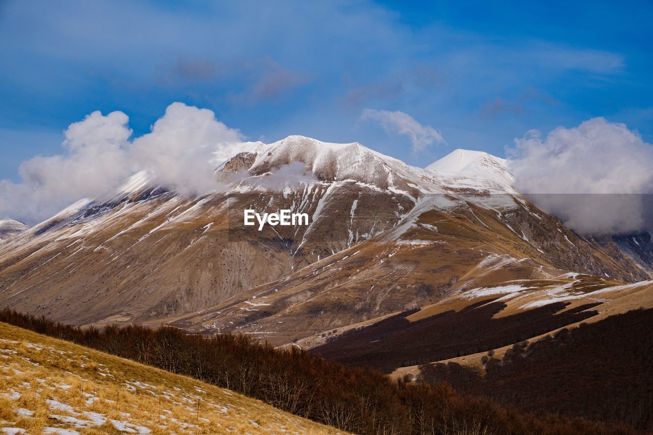 Scenic view of snowcapped mountains against sky
