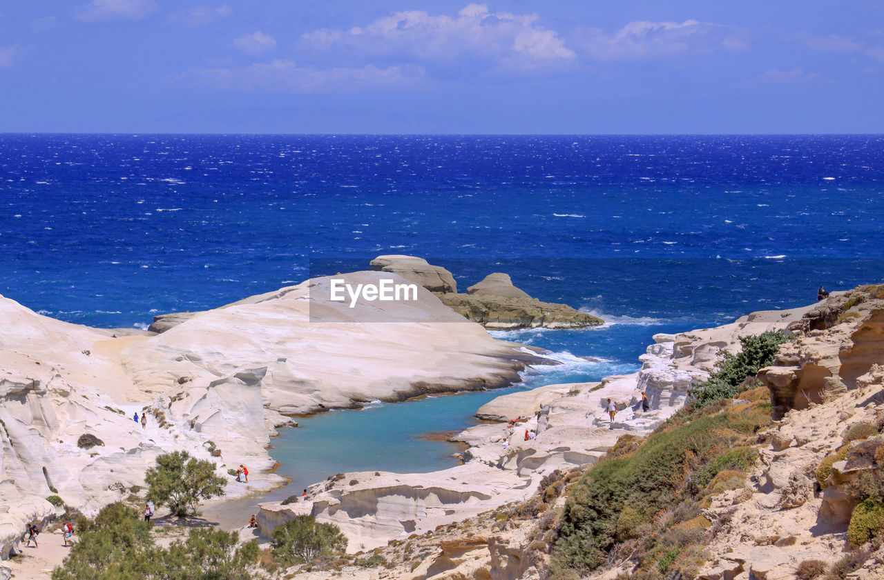 ROCKS ON BEACH AGAINST SKY