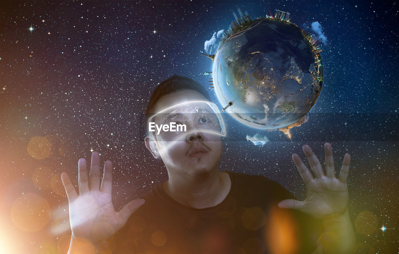 Digital composite image of man wearing eyewear looking at planet earth