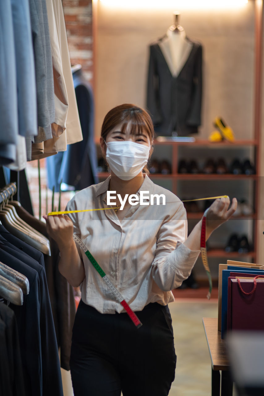 Staff taking care of clothes, suit-fitting staff