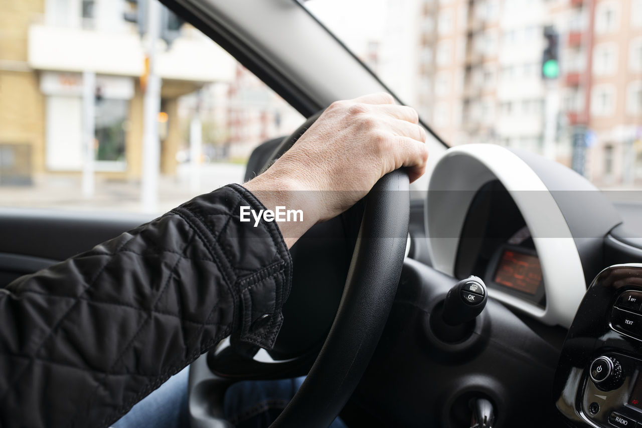 Hand on steering wheel