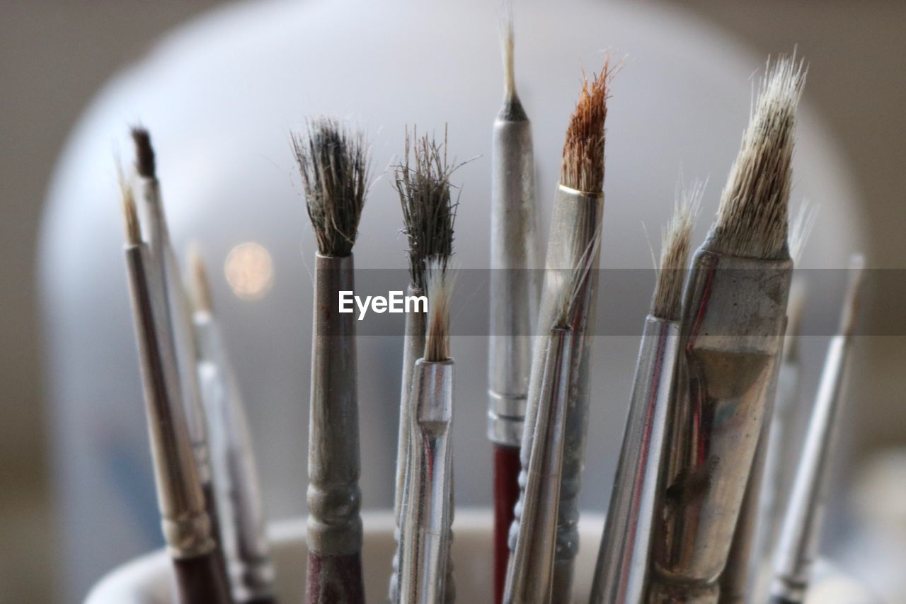 Close-up of paintbrushes in container