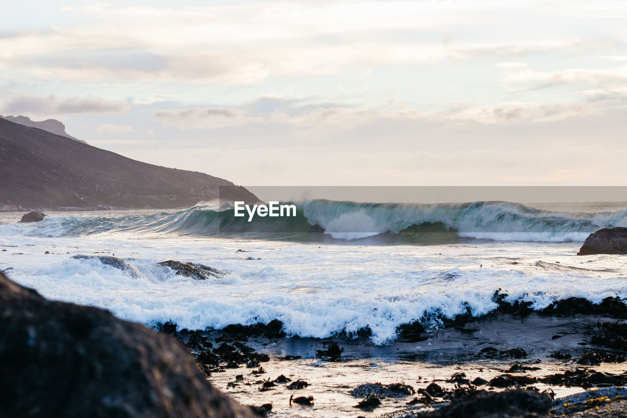 Scenic view of sea waves against sky