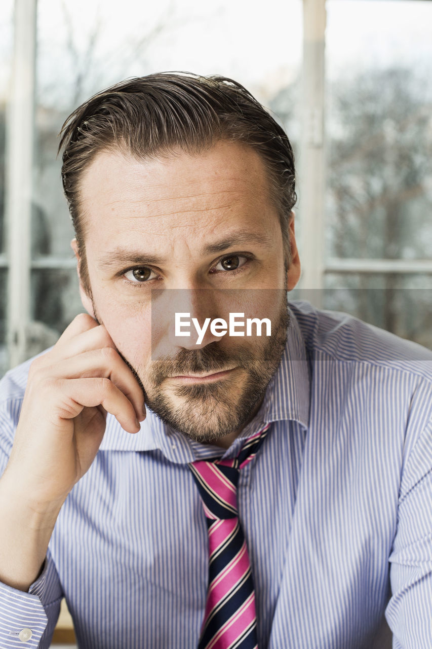 Portrait of confident mid adult businessman in office