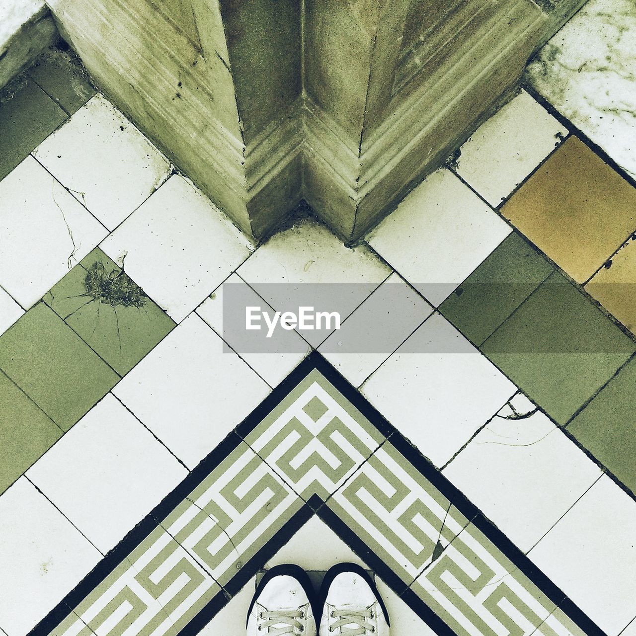 High angle view of pair of shoes on tiled floor