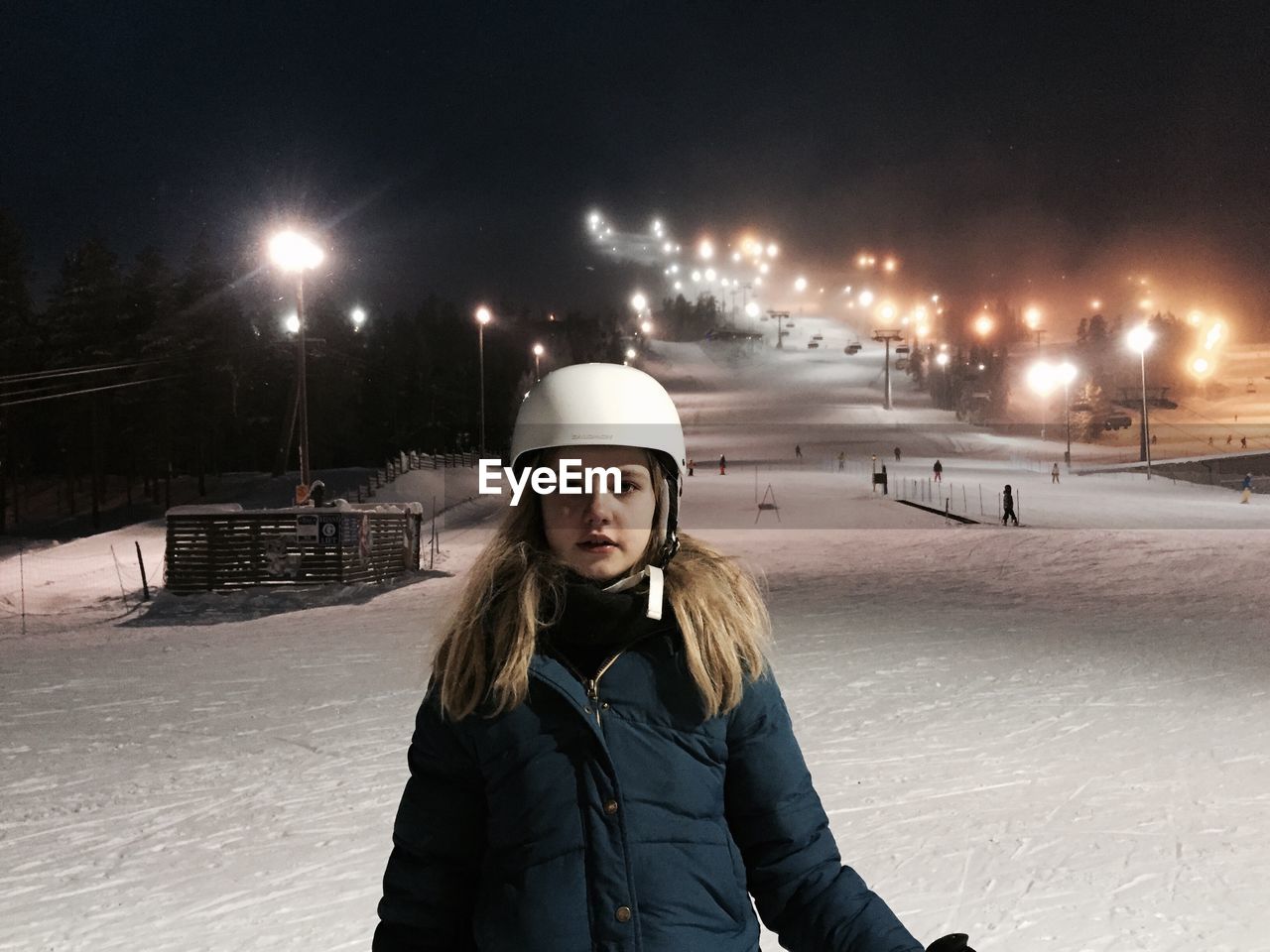 Portrait of woman at night on ski slope