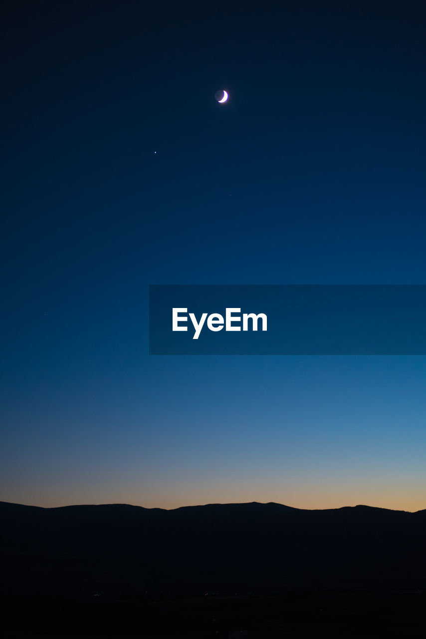 Scenic view of silhouette landscape against clear sky at night