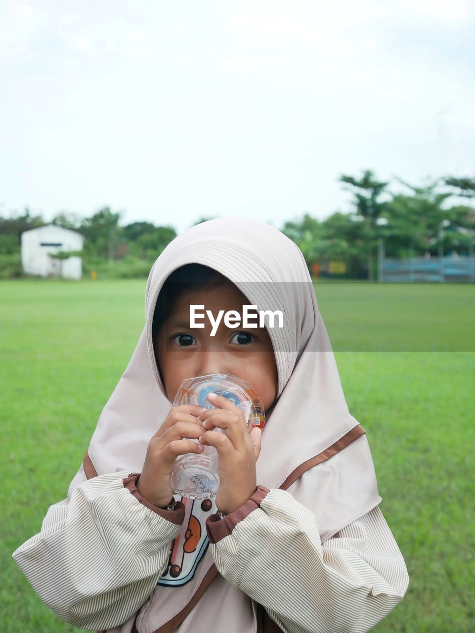 Portrait of cute girl drinking water