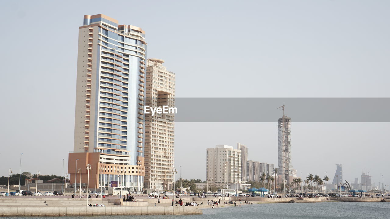 Modern buildings in city against clear sky