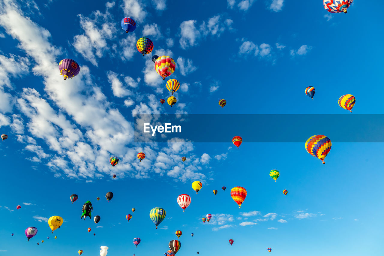 LOW ANGLE VIEW OF BALLOONS FLYING IN SKY
