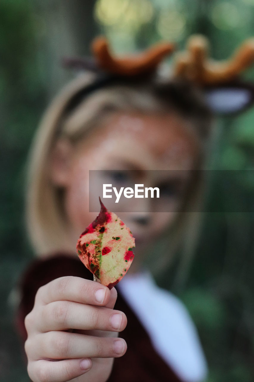 Portrait of girl holding leaf