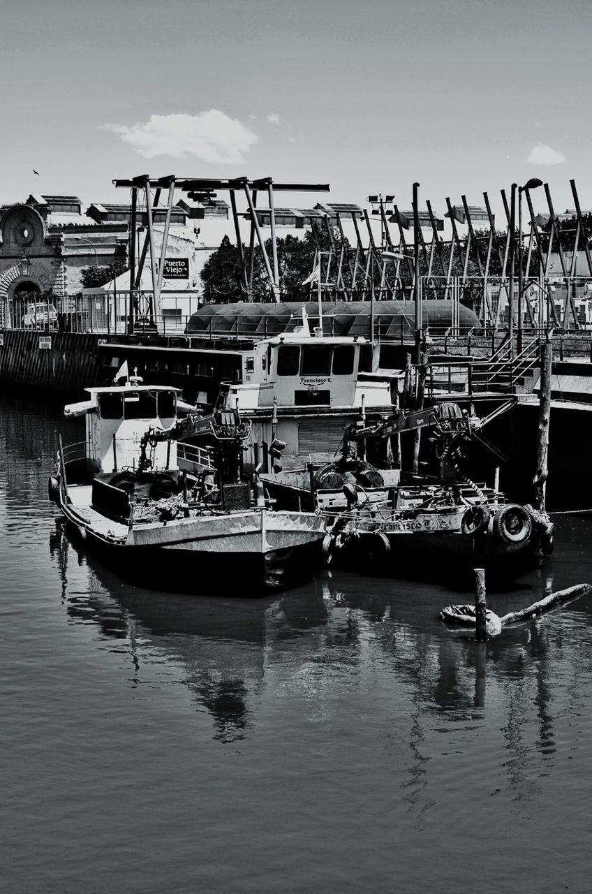 BOATS MOORED IN HARBOR