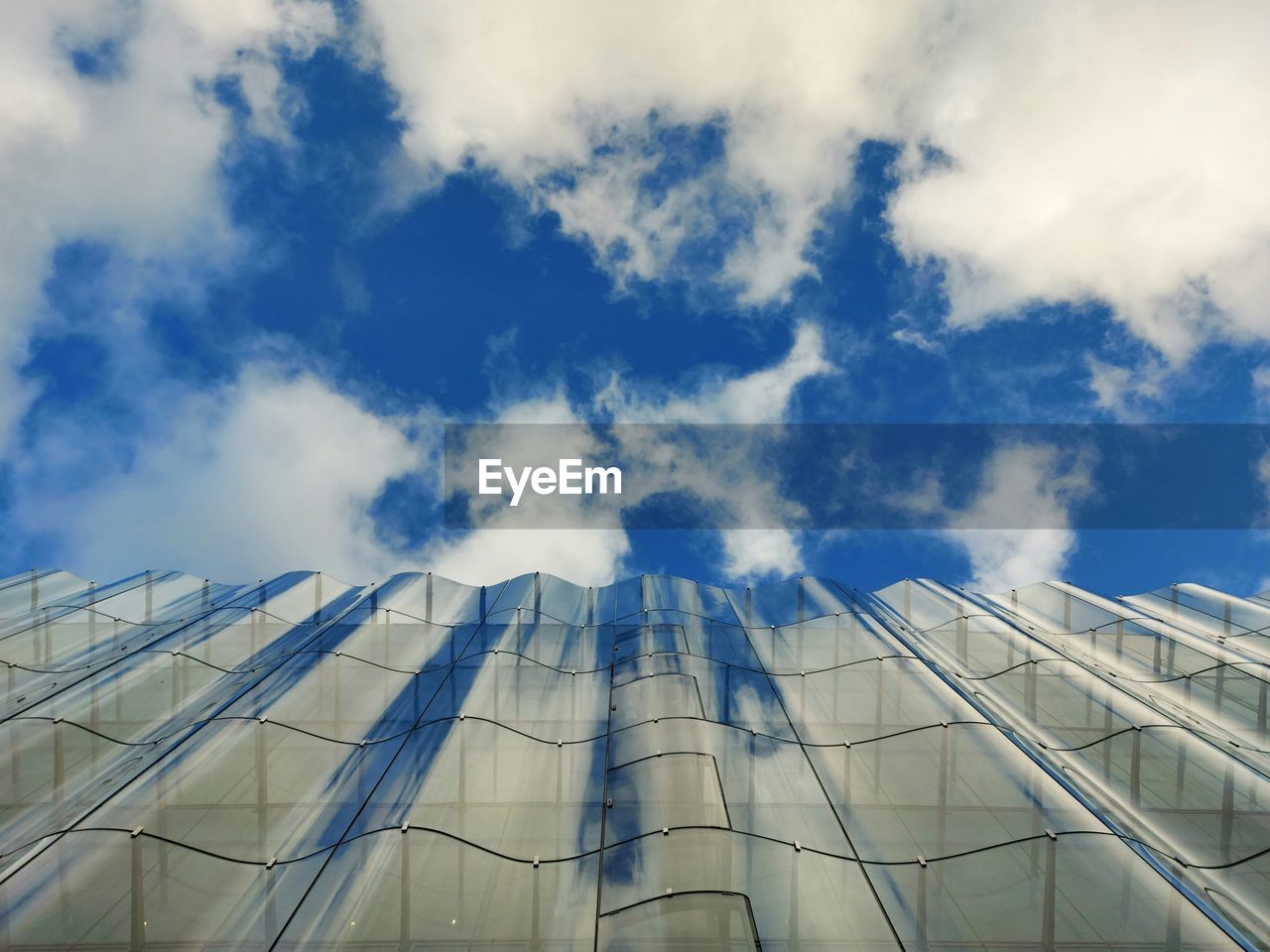 blue, sky, cloud, architecture, built structure, sunlight, building exterior, skyscraper, reflection, nature, no people, city, industry, glass, low angle view, building, outdoors, day, business, office building exterior, office, environment