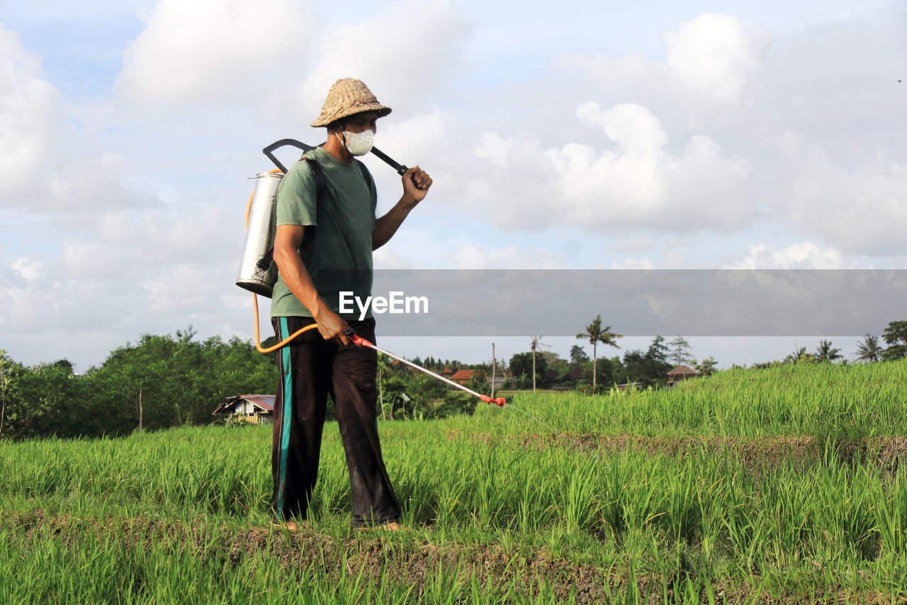 Rear view of a man standing on field