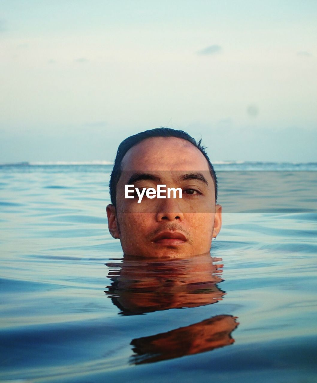 Portrait of man in infinity swimming pool