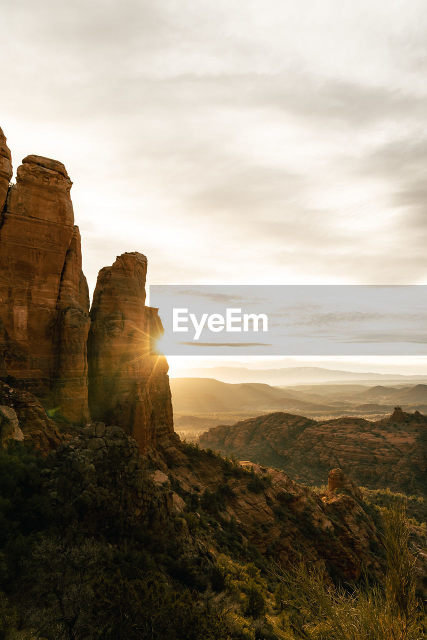 Sun flare on rock spires at the top of cathedral rock in sedona arizona