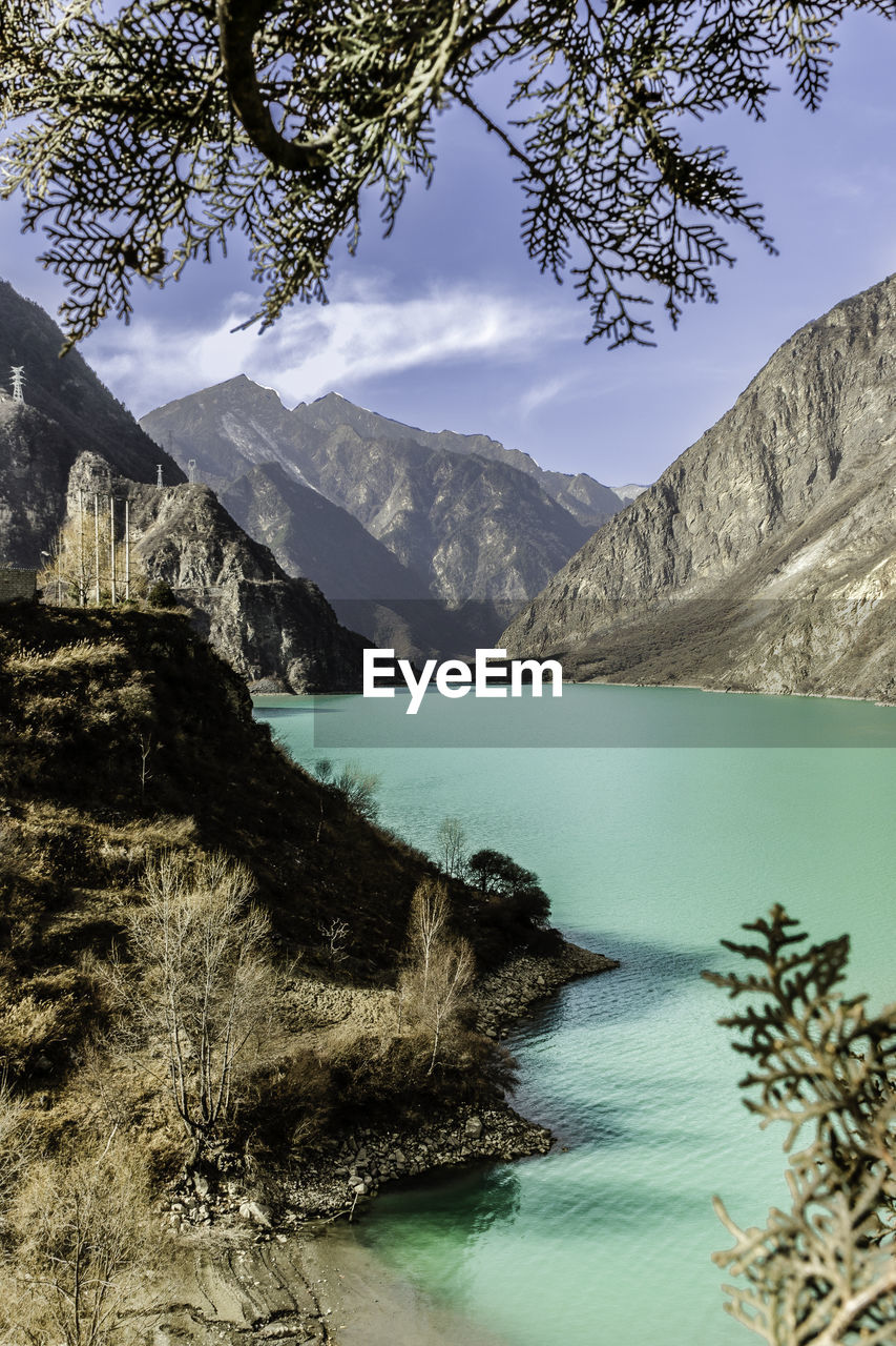 Scenic view of lake and mountains against sky