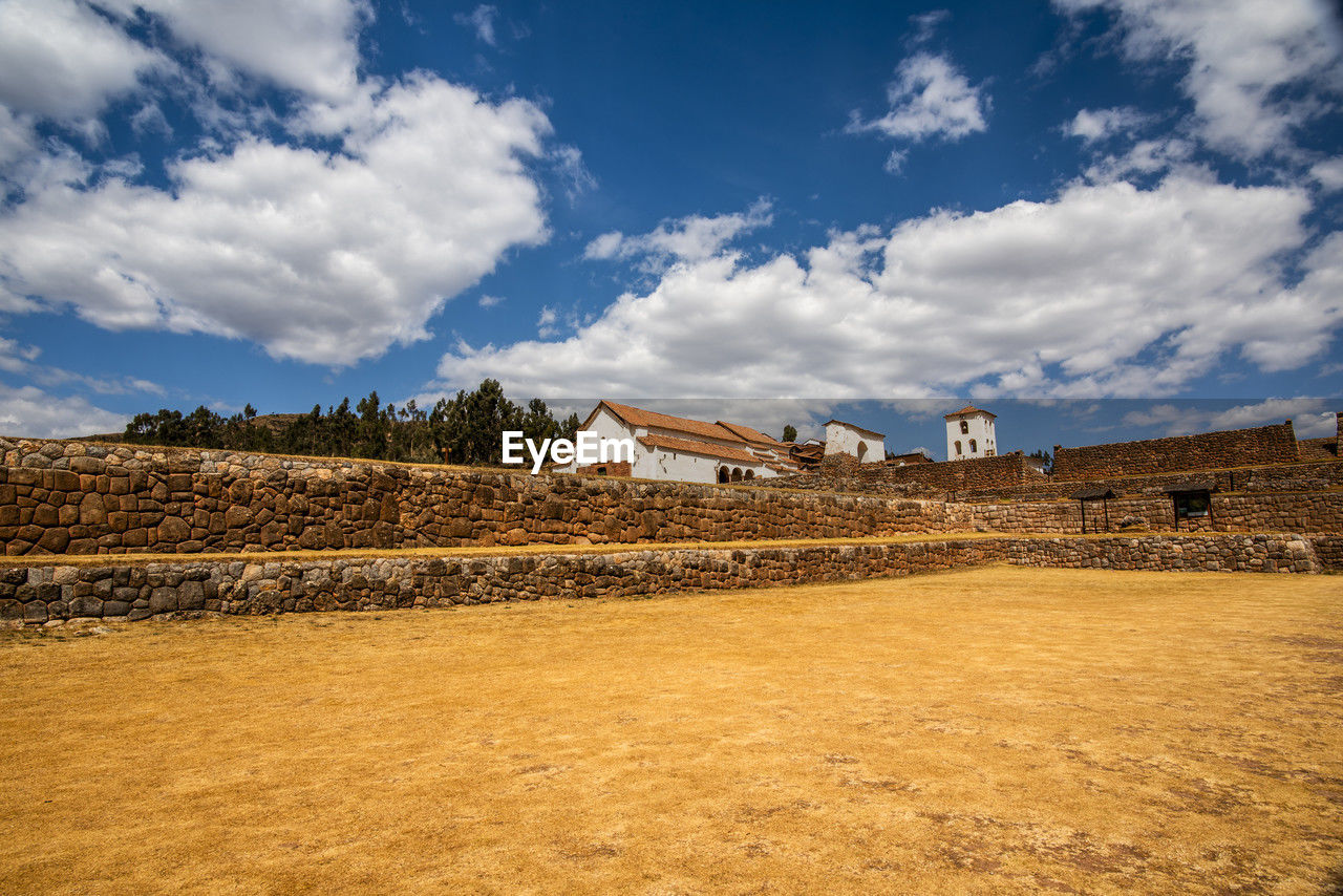 architecture, sky, built structure, cloud, building exterior, landscape, building, rural area, history, nature, the past, house, hill, travel destinations, environment, horizon, field, travel, sea, no people, land, ancient, outdoors, rural scene, blue, residential district, religion, tourism, sunlight, day, hut, scenics - nature, tradition