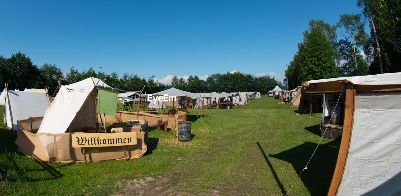 VIEW OF FIELD AGAINST CLEAR BLUE SKY