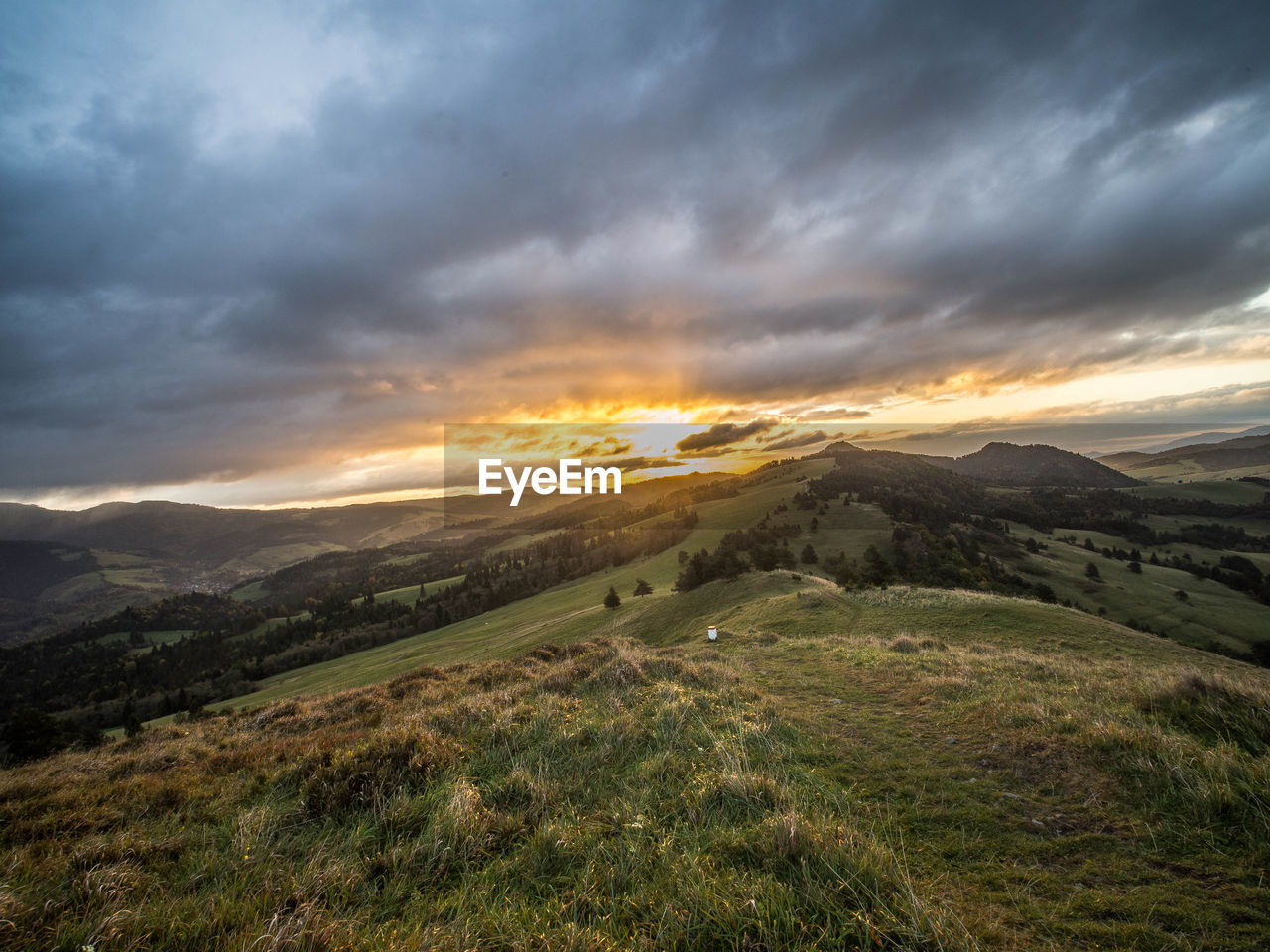 Scenic view of landscape against dramatic sky