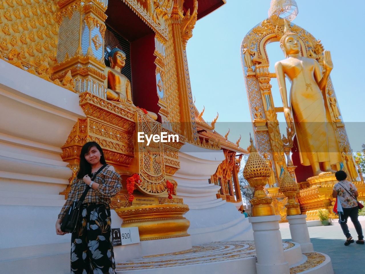 Woman standing against temple building