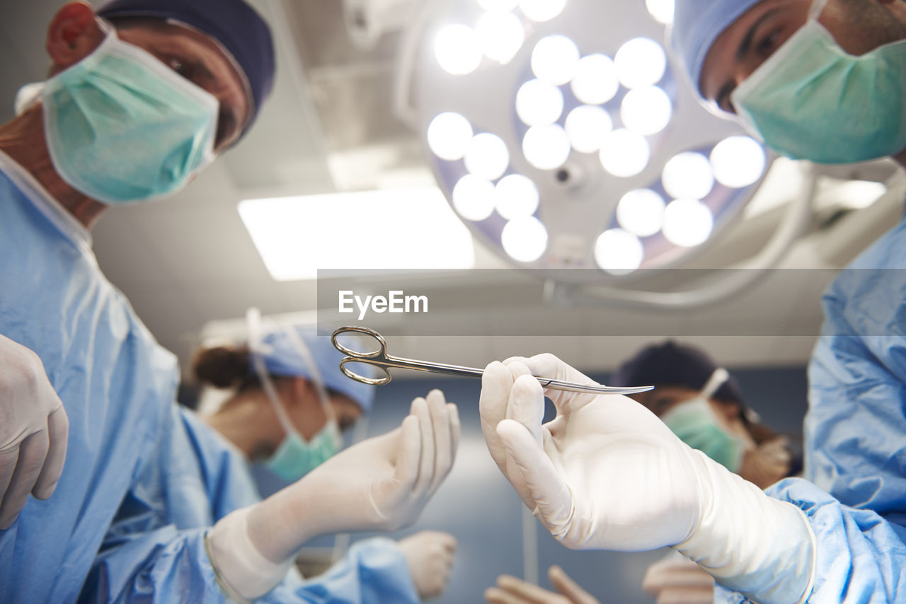 Low angle view of surgeons working in operating room