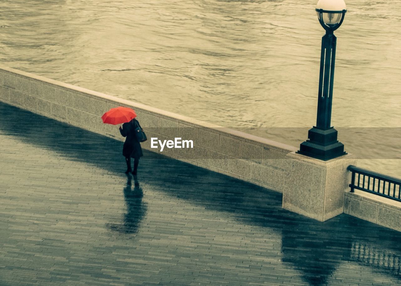 Woman under umbrella in rainy day