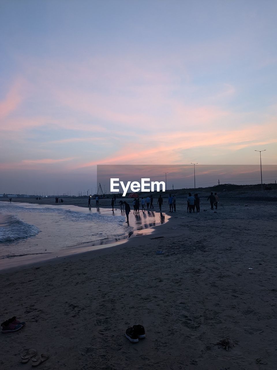 sky, sea, water, beach, land, ocean, body of water, sunset, shore, beauty in nature, nature, horizon, sand, scenics - nature, wave, coast, cloud, tranquility, horizon over water, dawn, tranquil scene, holiday, vacation, idyllic, trip, evening, wind wave, outdoors, travel destinations, group of people, travel, non-urban scene, environment, bay, sun, reflection, tourism, pier