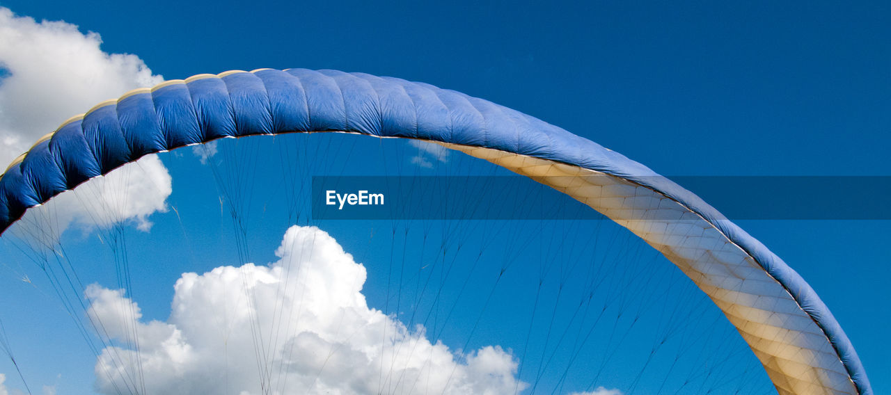 Low angle view of parachute against sky