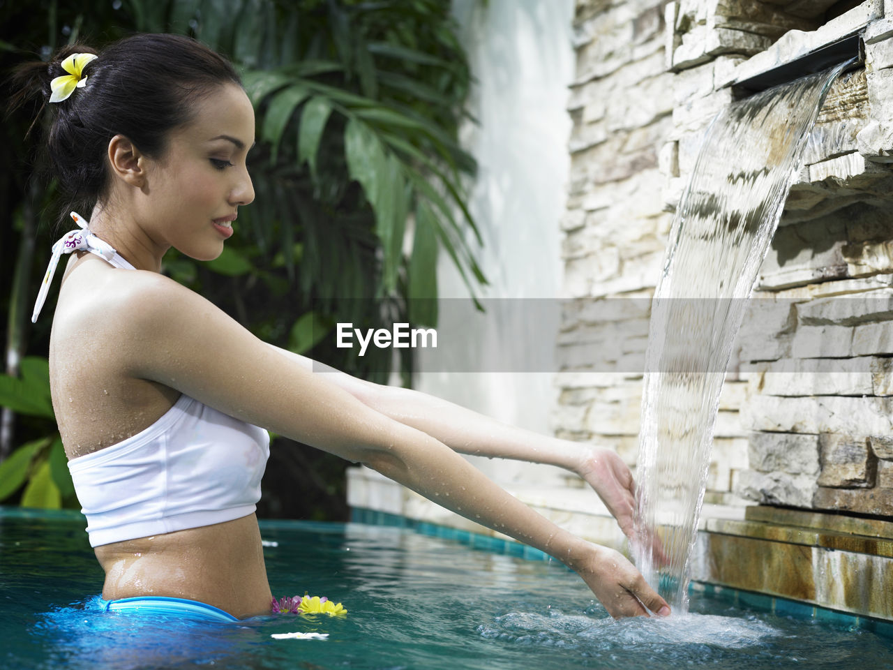 Side view of young woman in swimming pool