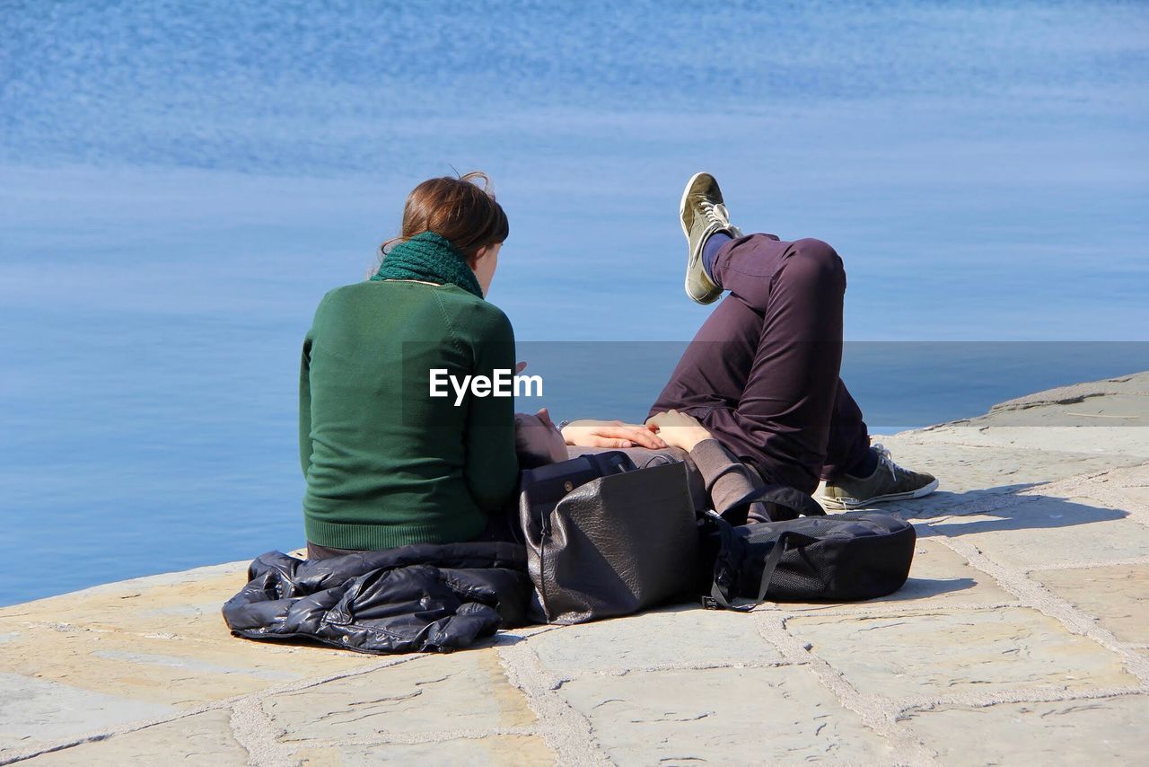 Couple on footpath against sea