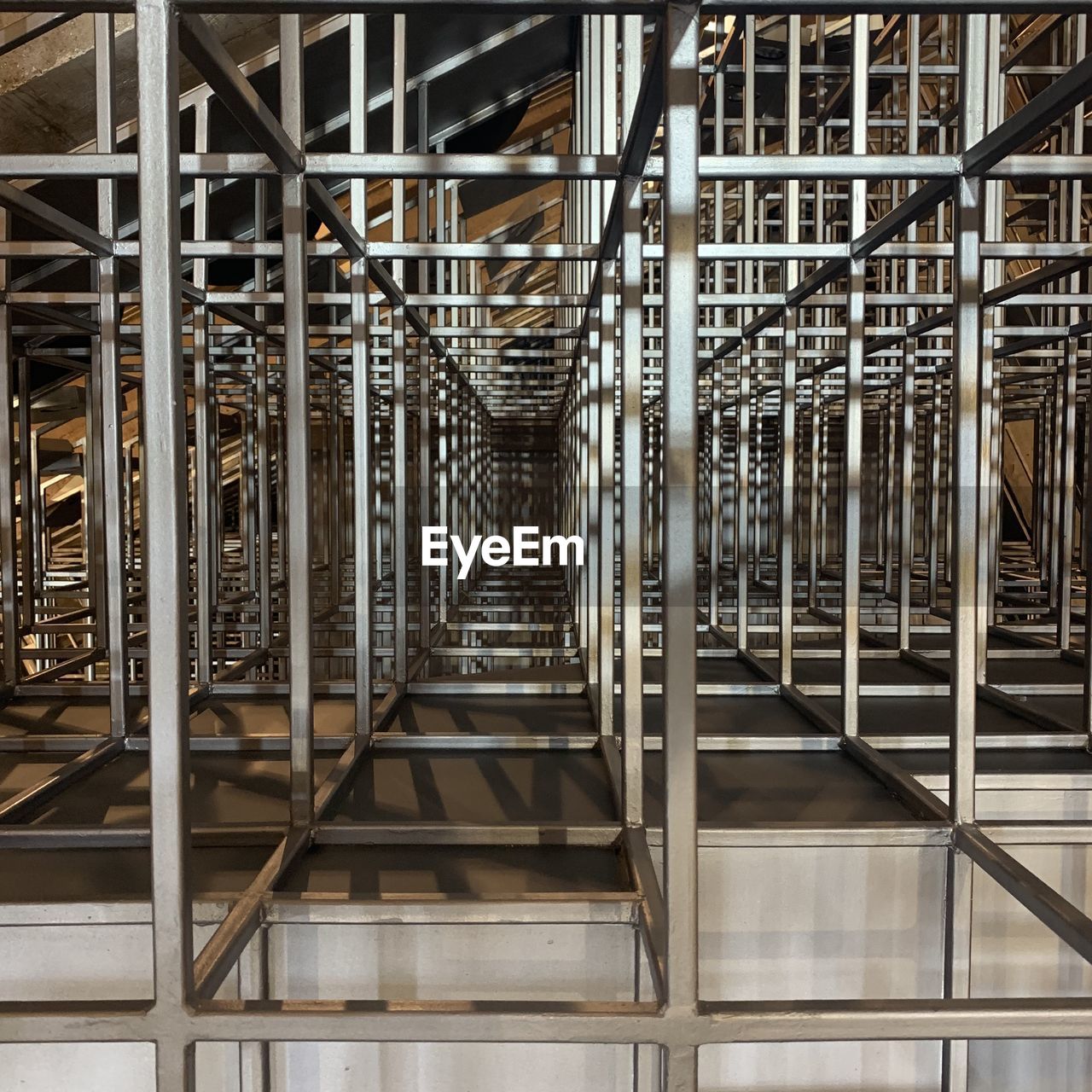 DIRECTLY BELOW SHOT OF METAL STAIRCASES IN BUILDING