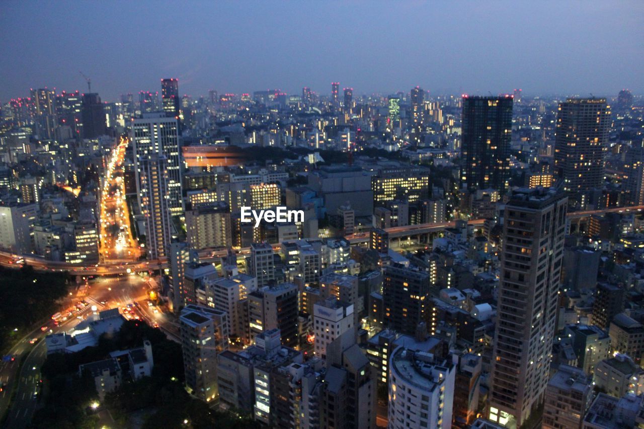 High angle view of city lit up at night