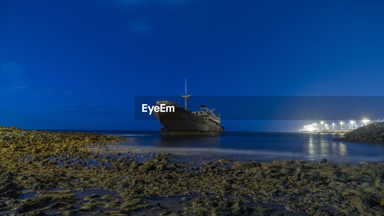 PANORAMIC VIEW OF SEA AGAINST CLEAR BLUE SKY AT NIGHT