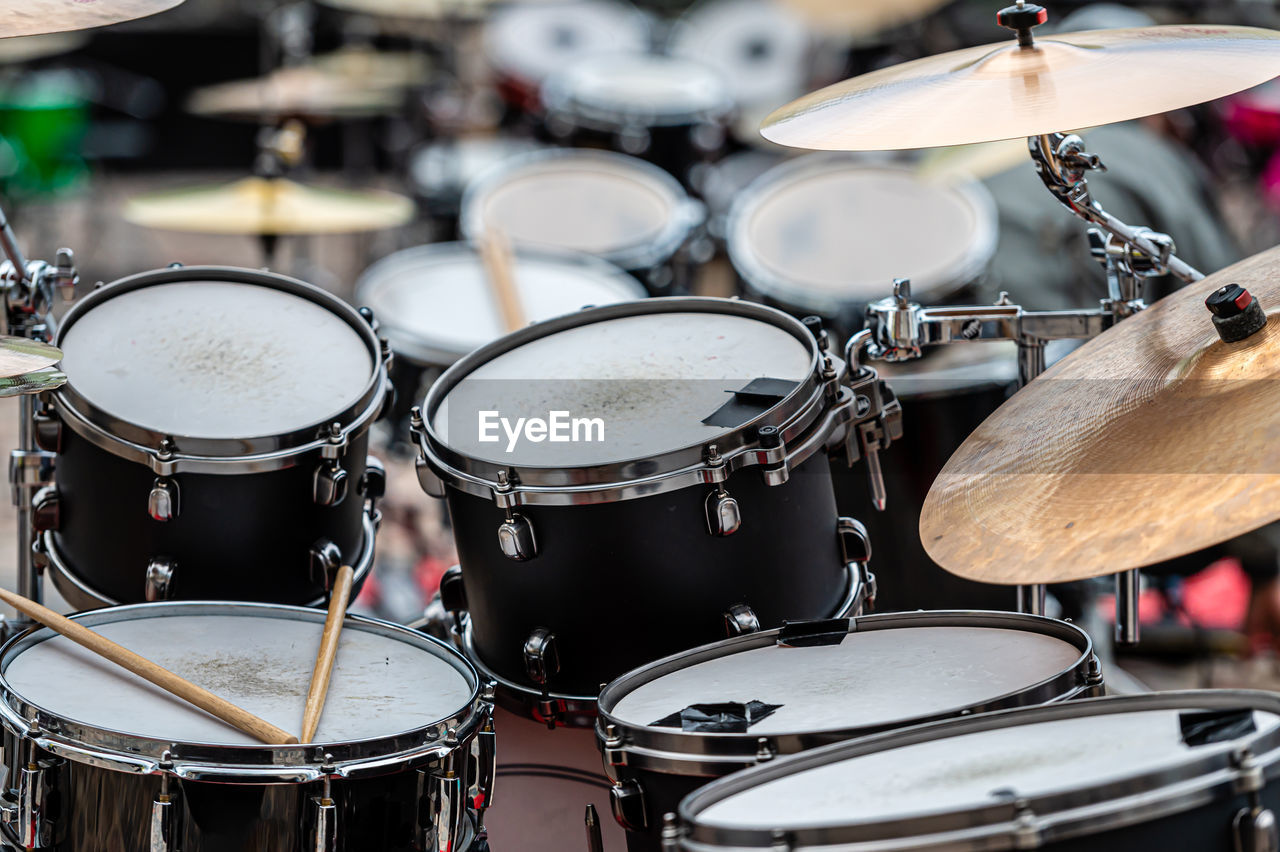 A set of plates in a drum set. at a concert of percussion music, selective focus, close-up
