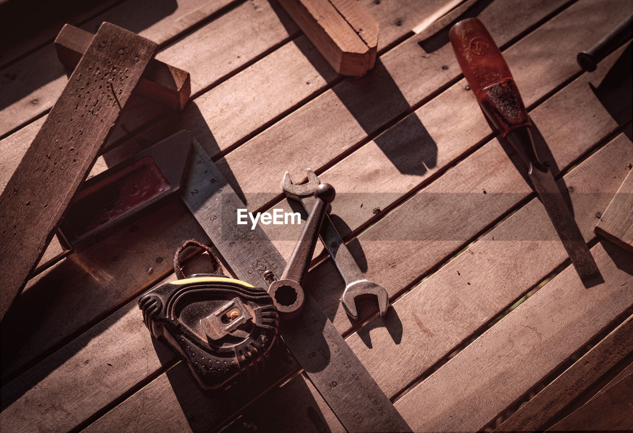 Old rusted hammer, screwdriver and nail on old wooden table. woodwork tools for fix and repair home.